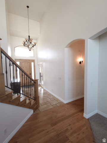 552 Sunset Crest Way Draper, UT 84020 - Photo 17 of 68 Stairs with arched walkways, a high ceiling, and wood finished floors