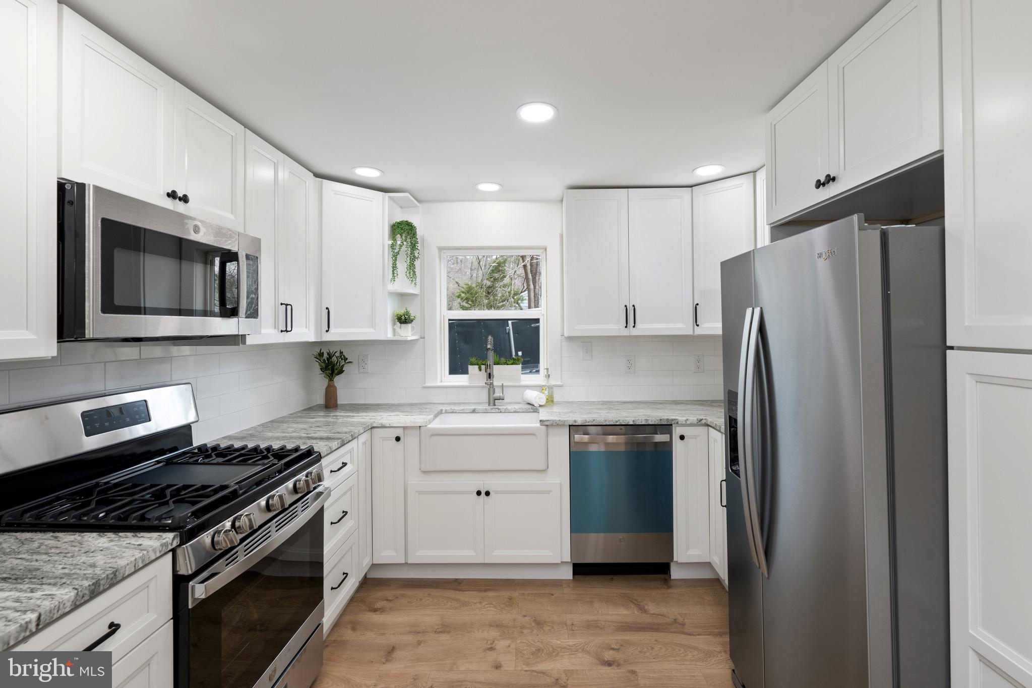 18316 Shingle Point Road Georgetown, DE 19947 - Photo 11 of 35 a kitchen with stainless steel appliances a stove microwave and refrigerator