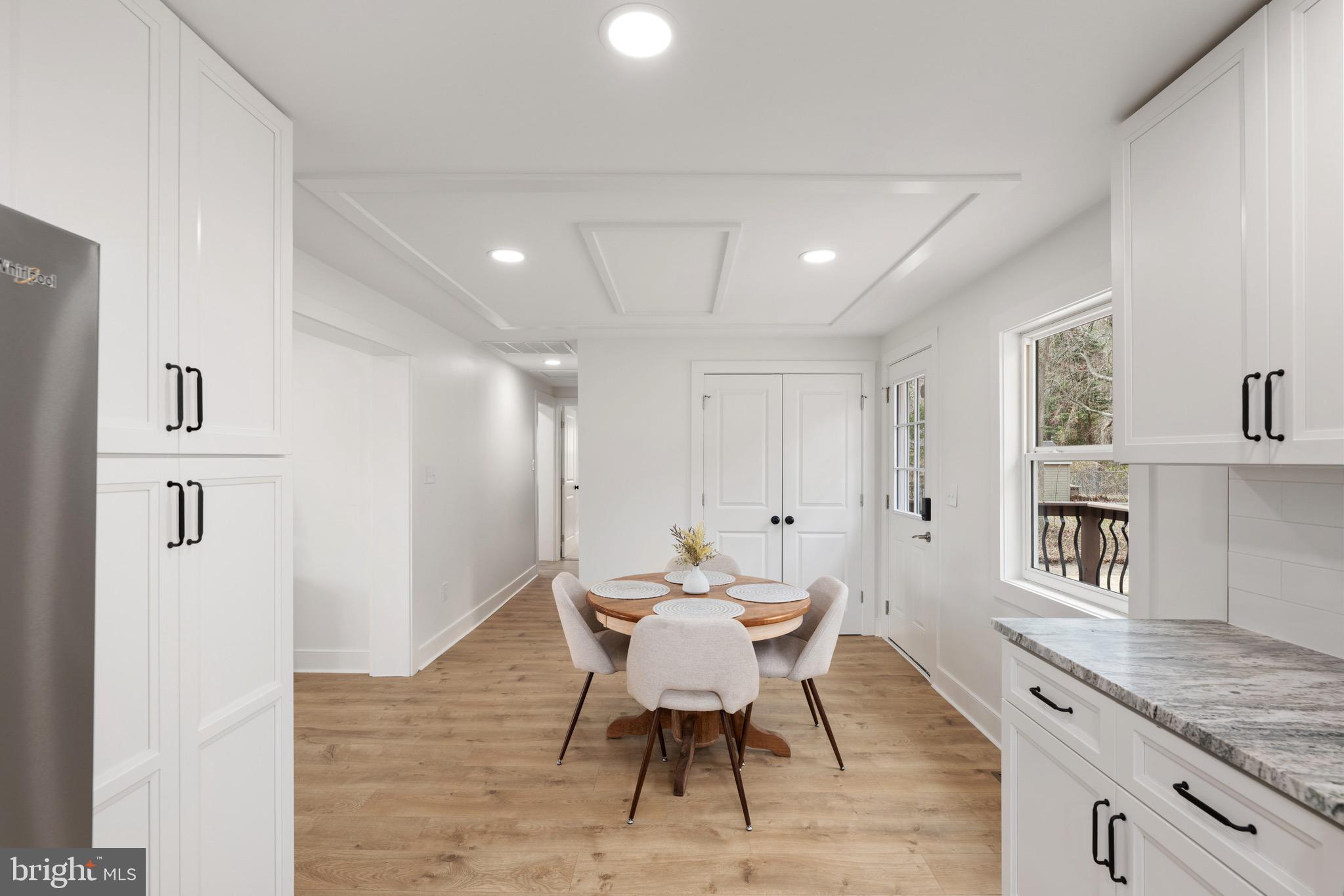 18316 Shingle Point Road Georgetown, DE 19947 - Photo 14 of 35 a view of a dining room with furniture and wooden floor