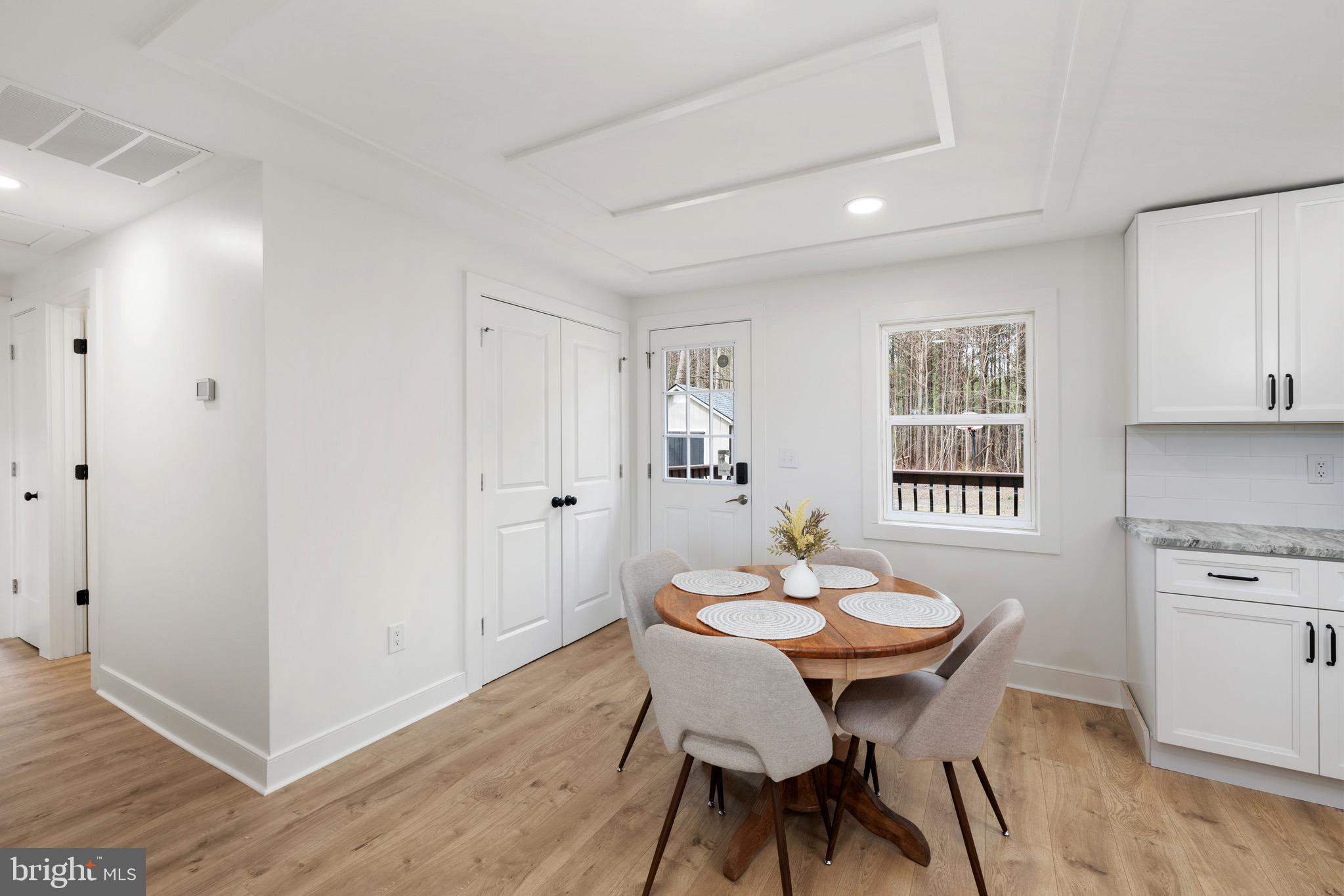 18316 Shingle Point Road Georgetown, DE 19947 - Photo 15 of 35 a view of a dining room with furniture and wooden floor