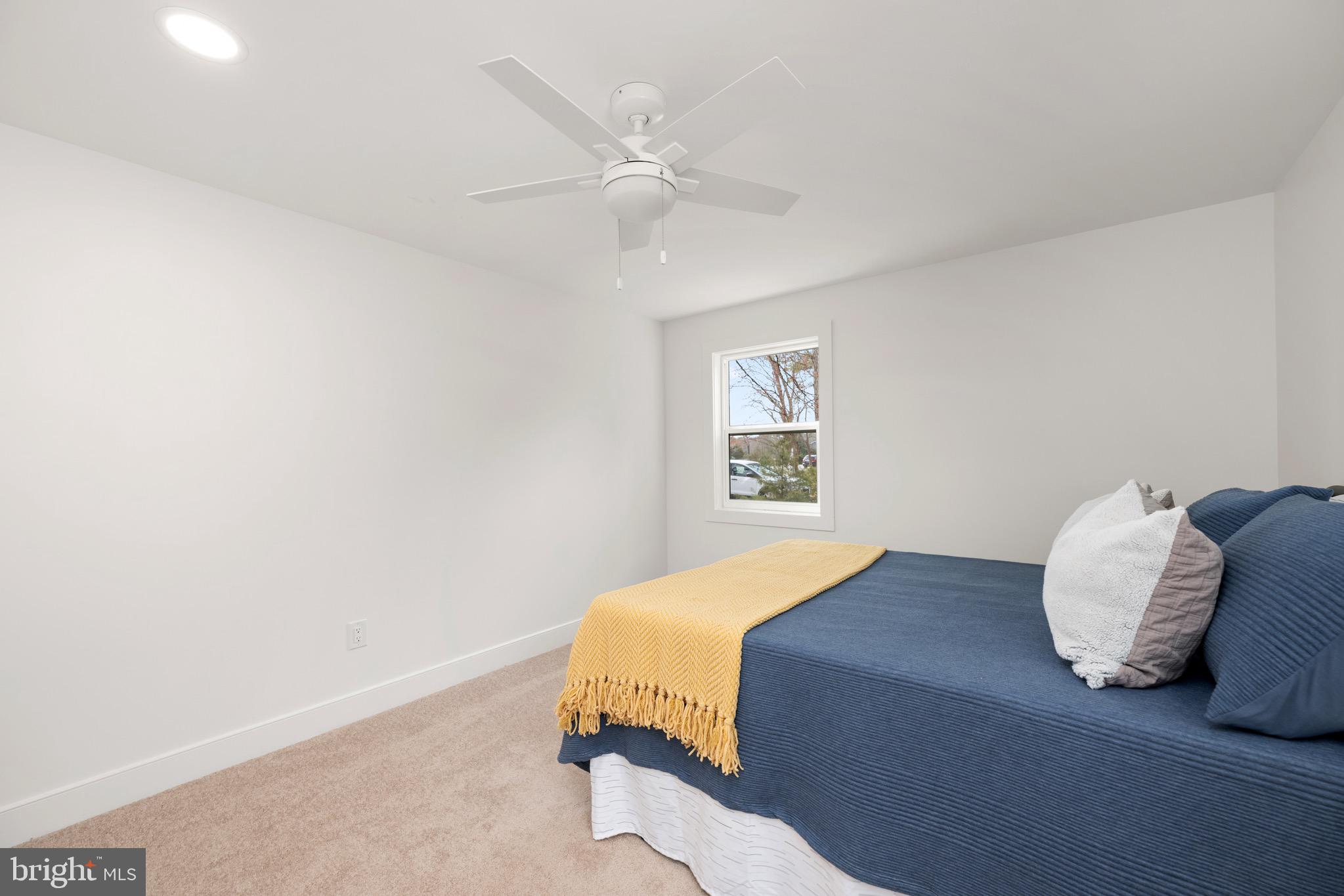 18316 Shingle Point Road Georgetown, DE 19947 - Photo 18 of 35 a bedroom with a bed and a window