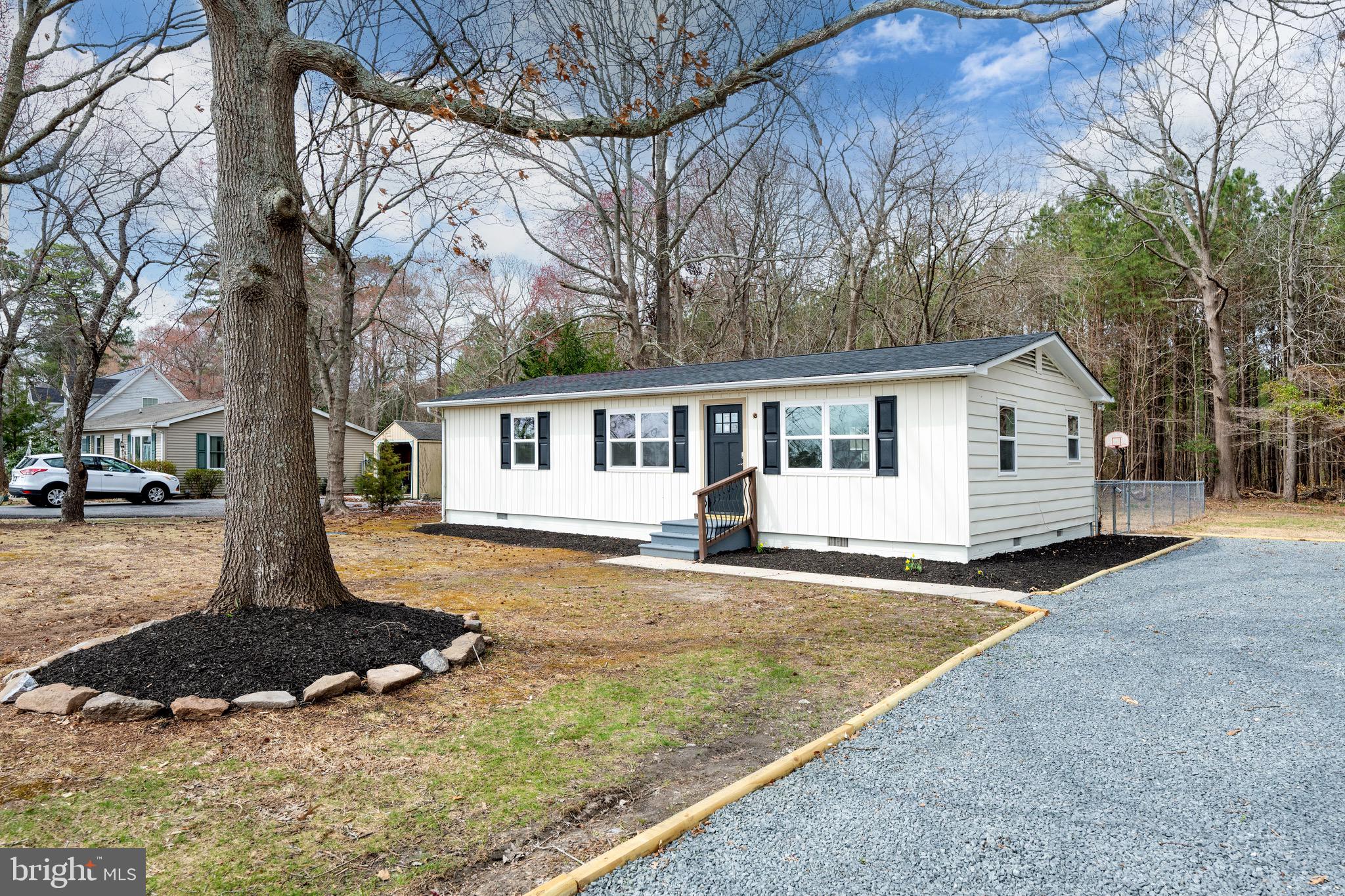 18316 Shingle Point Road Georgetown, DE 19947 - Photo 2 of 35 a front view of a house with a yard