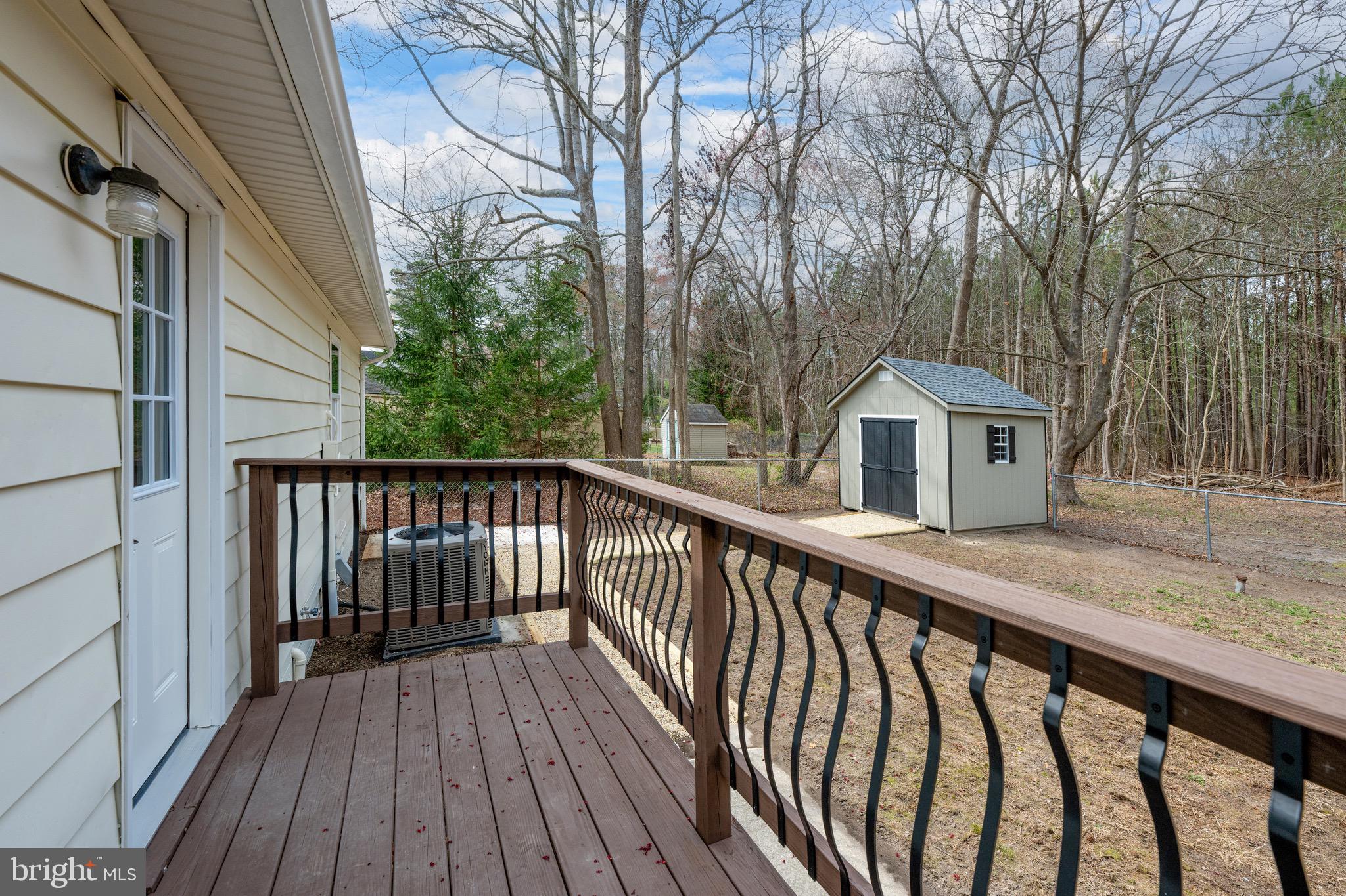 18316 Shingle Point Road Georgetown, DE 19947 - Photo 28 of 35 a view of wooden deck and a trees