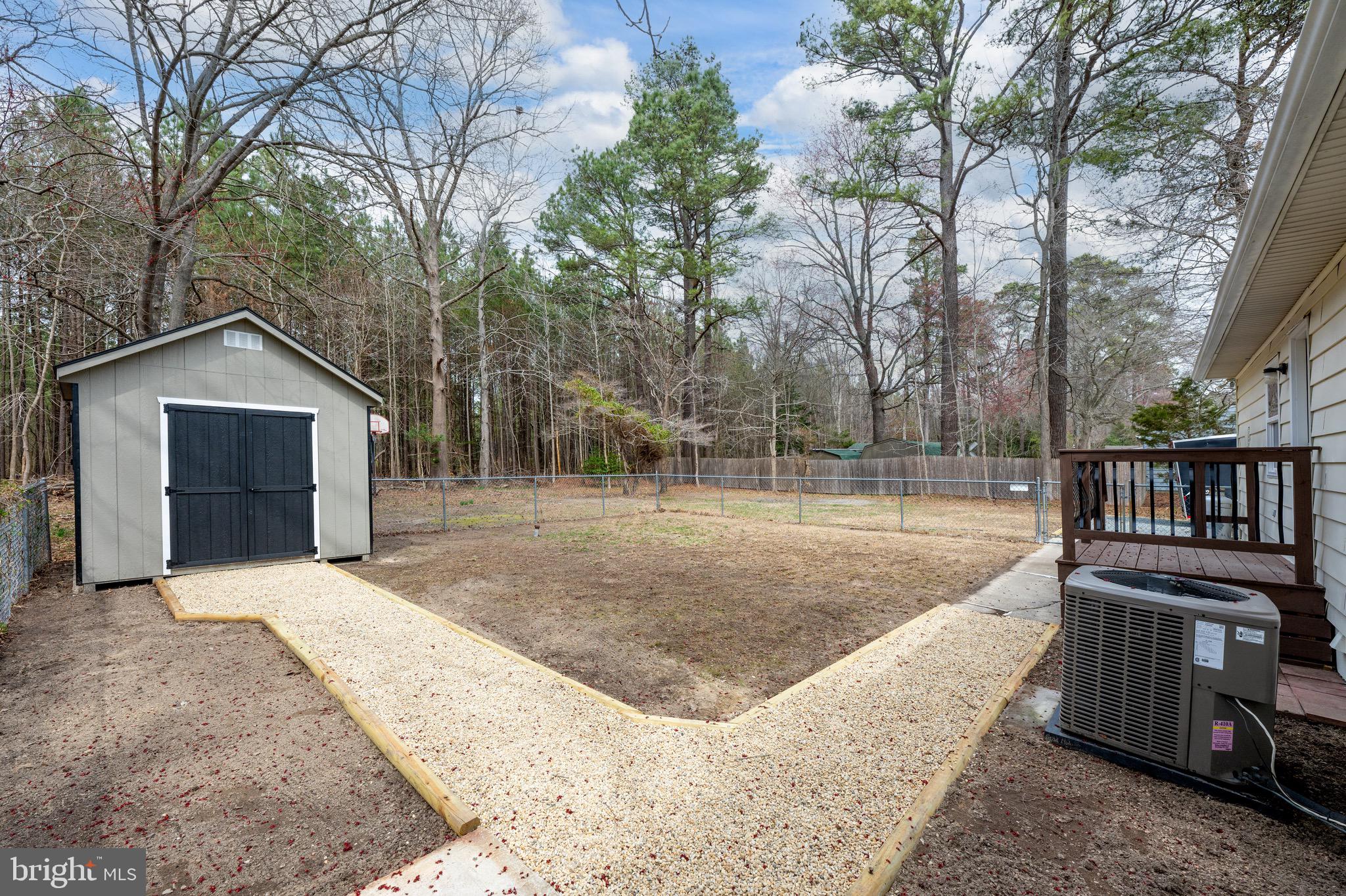 18316 Shingle Point Road Georgetown, DE 19947 - Photo 29 of 35 a view of a backyard with wooden fence