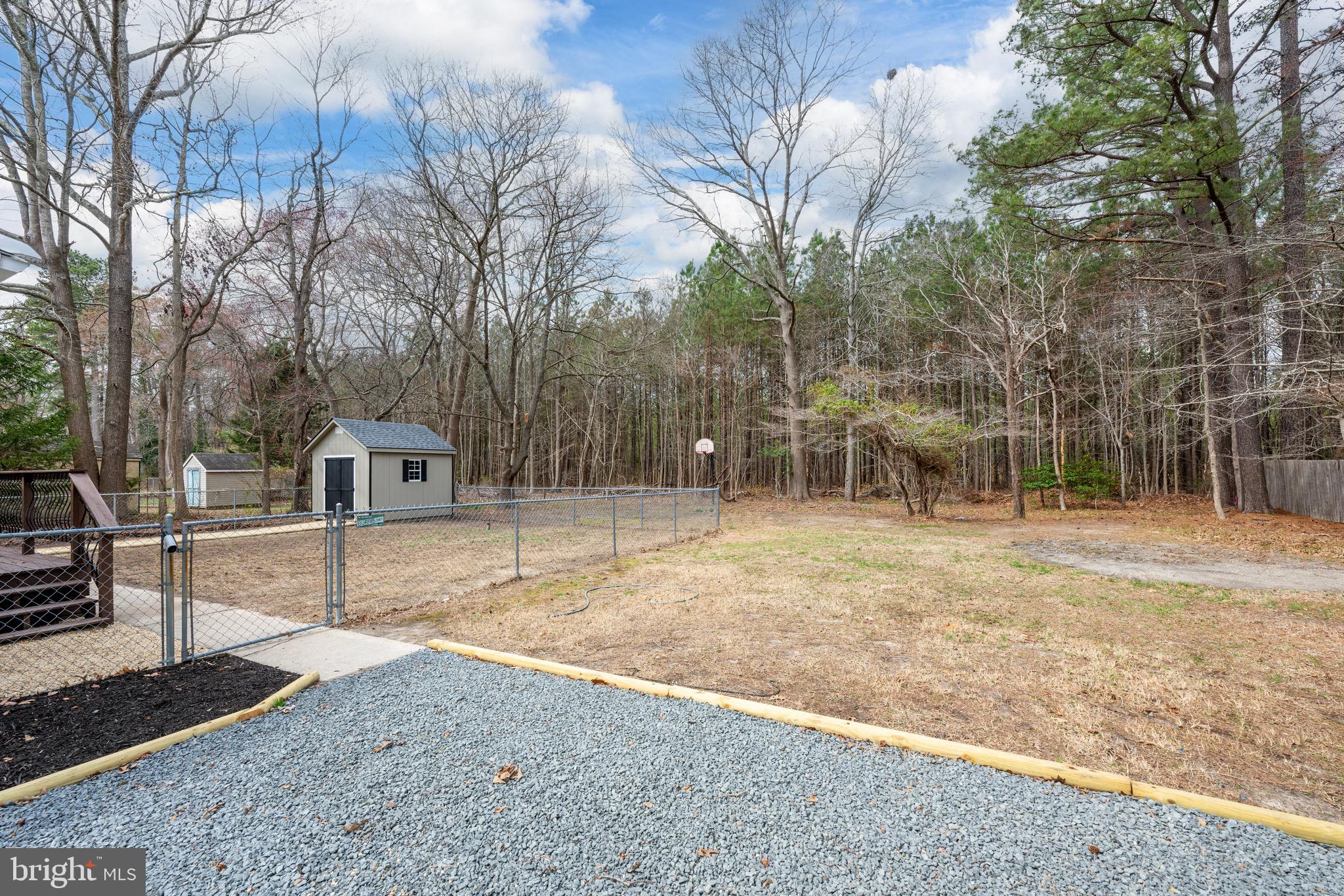 18316 Shingle Point Road Georgetown, DE 19947 - Photo 32 of 35 a backyard of a house with lots of green space