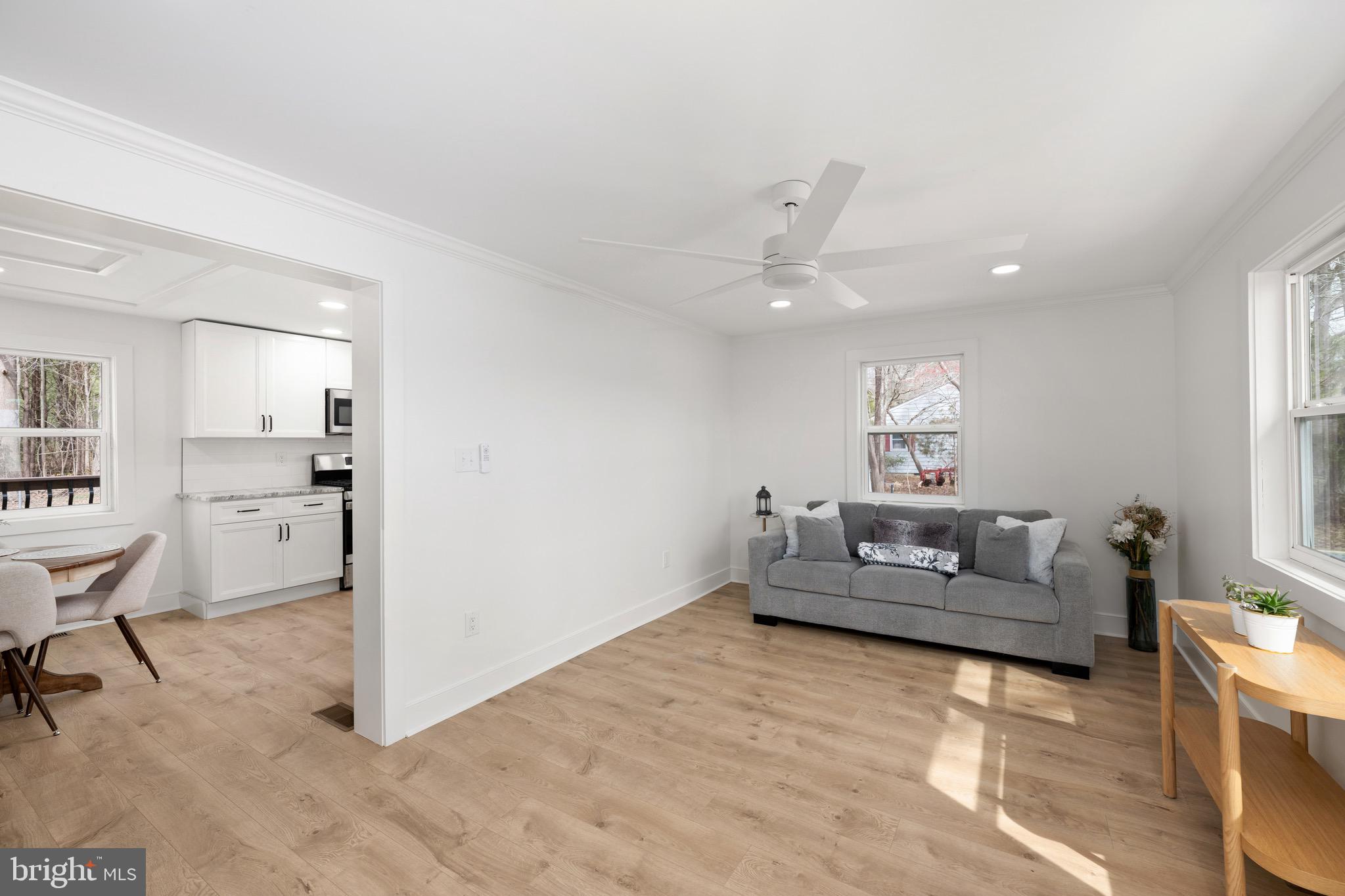 18316 Shingle Point Road Georgetown, DE 19947 - Photo 6 of 35 a living room with furniture and a wooden floor