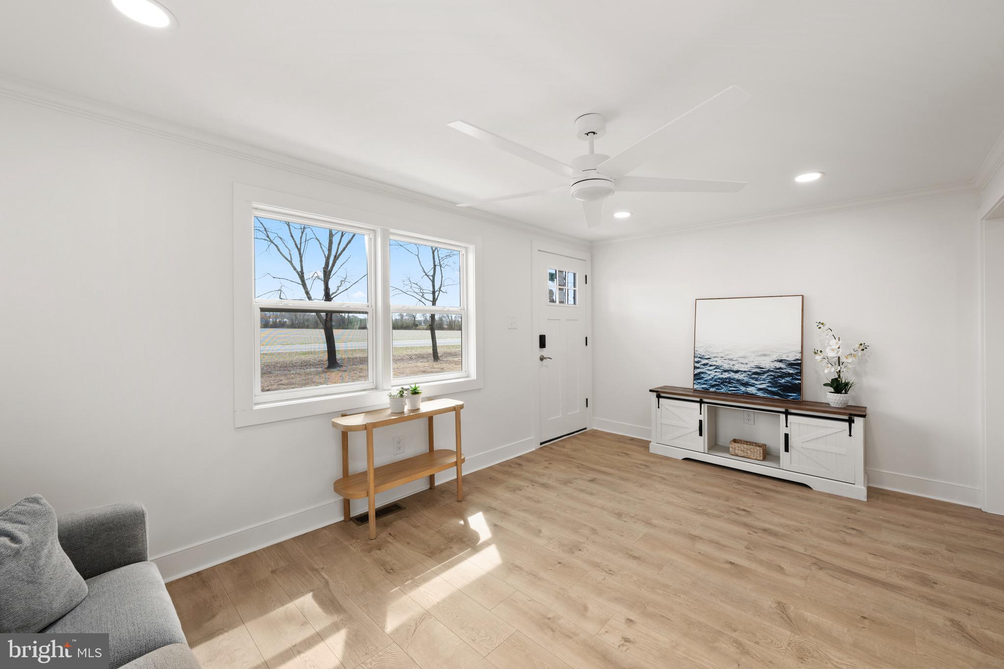 18316 Shingle Point Road Georgetown, DE 19947 - Photo 9 of 35 a living room with furniture a window and a table