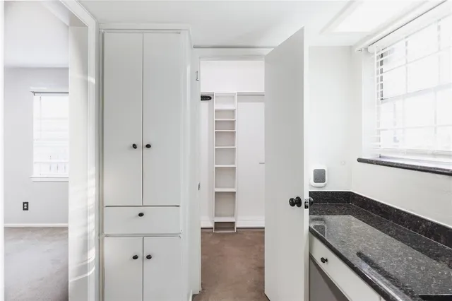 a kitchen with granite countertop cabinets and window