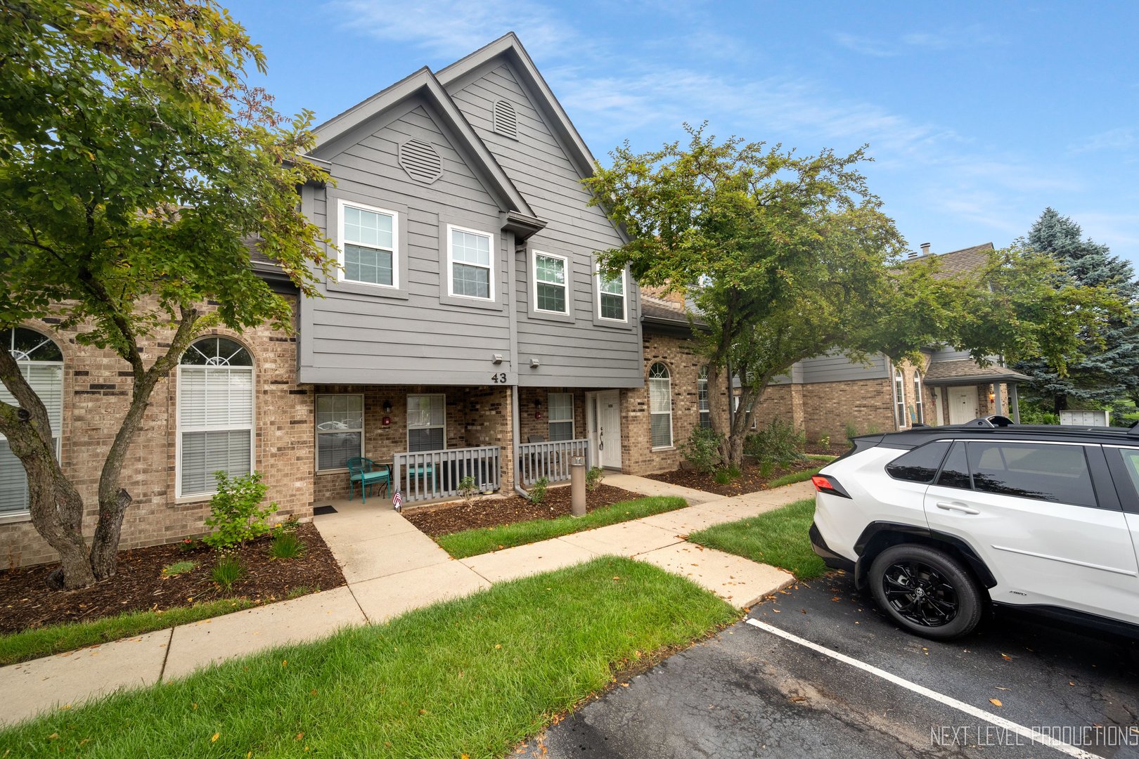 43 Foxcroft Road, Unit 119 Naperville, IL 60565 - Photo 1 of 13 a view of a house with a yard