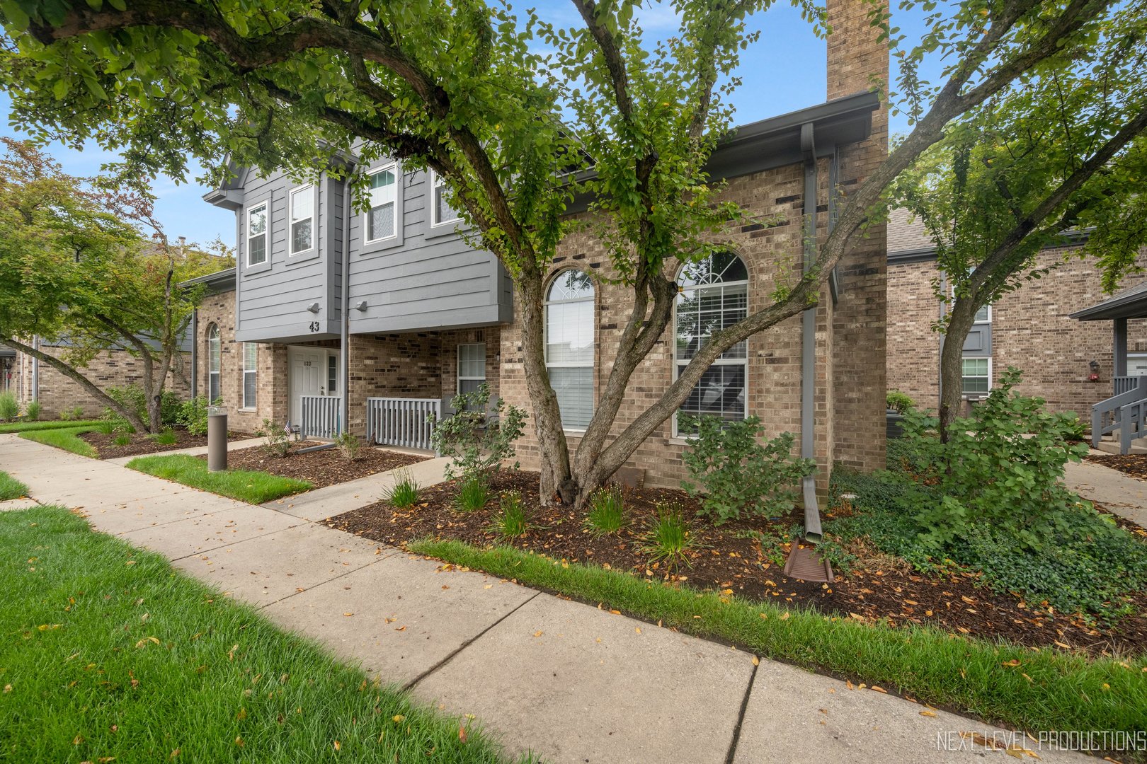 43 Foxcroft Road, Unit 119 Naperville, IL 60565 - Photo 3 of 13 a front view of a house with garden