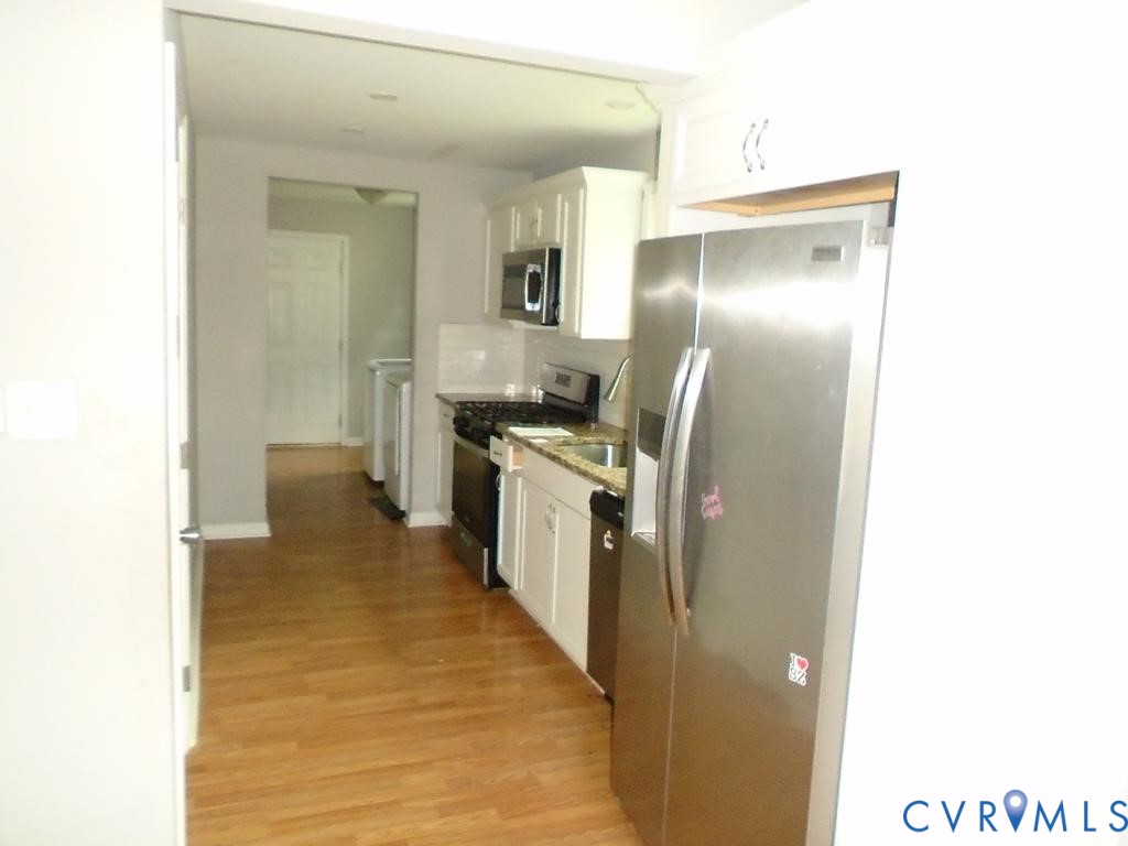 3406 Mike Road Richmond, VA 23234 - Photo 10 of 15 Kitchen featuring wood-finish flooring, white cabi
