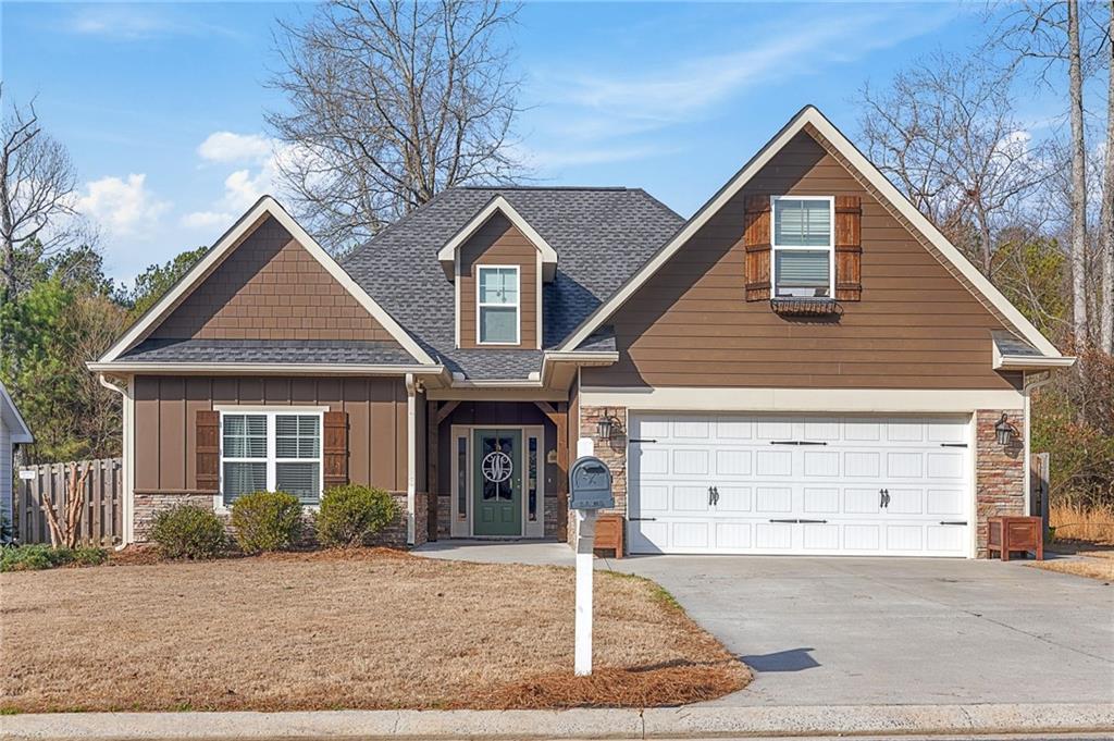 60 Round Rock Circle Northeast Rome, GA 30161 - Photo 1 of 1 a front view of a house with a yard and garage