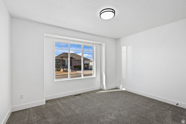 1139 South 4475 West West Point, UT 84015 - Photo 13 of 33 Empty room featuring carpet floors and a textured ceiling