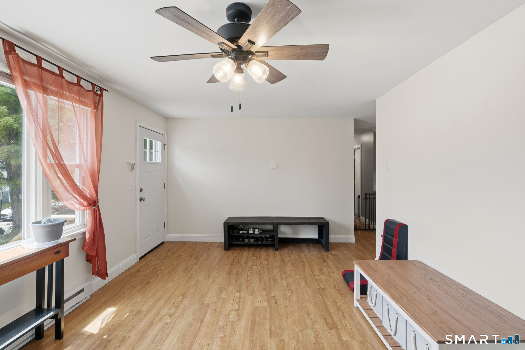 71 Smith Street Putnam, CT 06260 - Photo 12 of 25 a living room with a bed furniture and a window