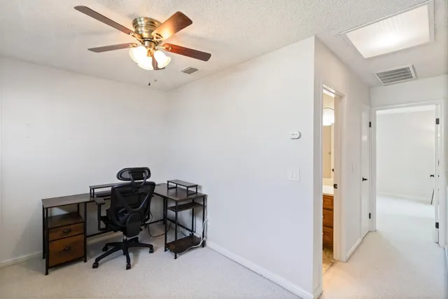 a view of a workspace with furniture