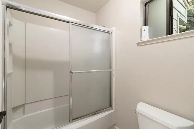 a bathroom with a shower and a toilet