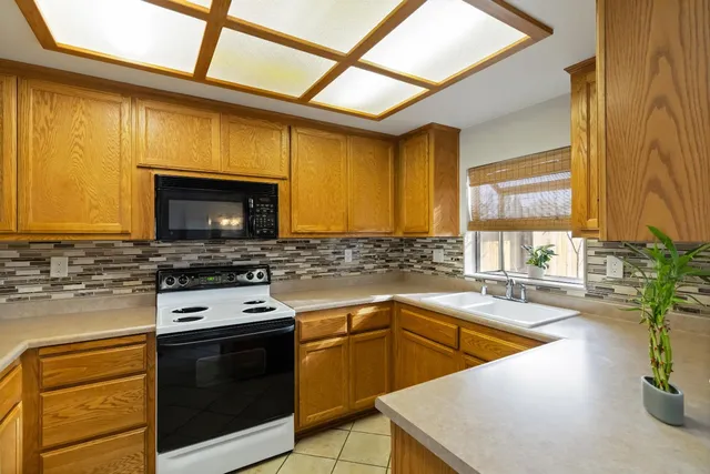 a kitchen with a stove a sink and a microwave