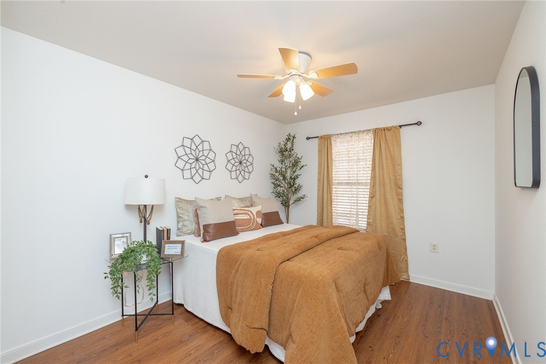 3520 East Richmond Road, Unit U106 Richmond, VA 23223 - Photo 11 of 18 a bed room with a bed and a chandelier