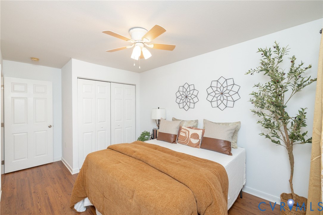 3520 East Richmond Road, Unit U106 Richmond, VA 23223 - Photo 12 of 18 a bedroom with a large bed and a chandelier