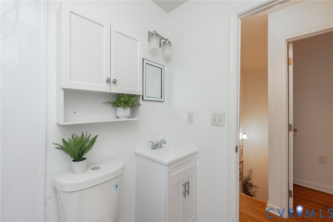 3520 East Richmond Road, Unit U106 Richmond, VA 23223 - Photo 14 of 18 a bathroom with a sink a mirror and a window