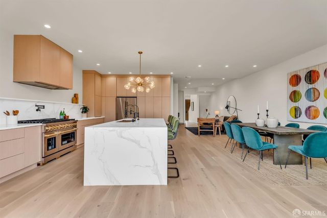 a living room with furniture and kitchen view
