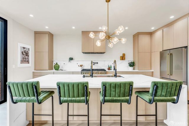 a large kitchen with a table and chairs