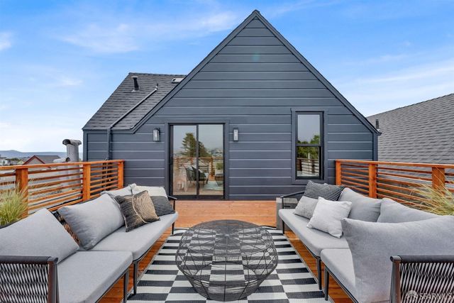 a balcony with furniture and a potted plant