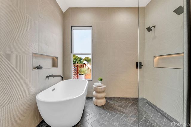 a white bath tub sitting next to a white sink