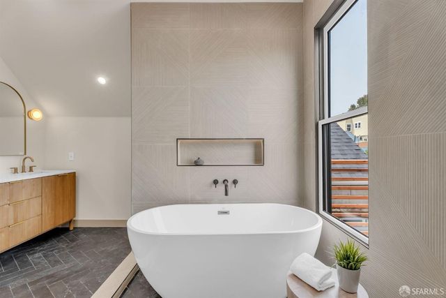 a bathroom with double vanity sinks and a mirror