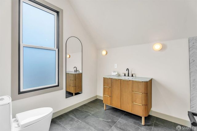 a living room with furniture a rug and a large window