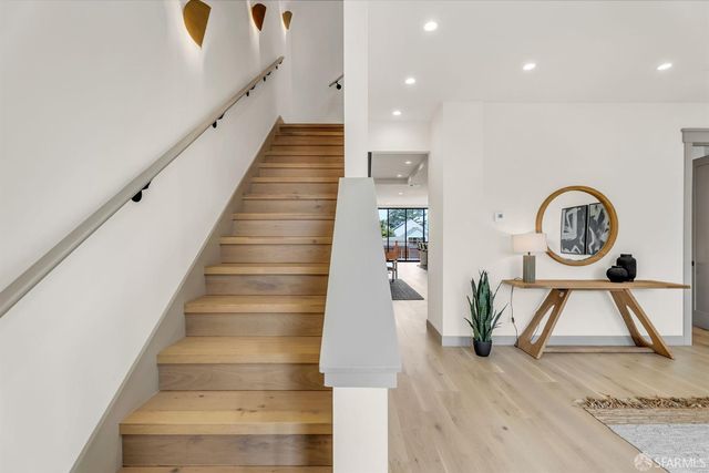 a view of entryway and hall with wooden floor