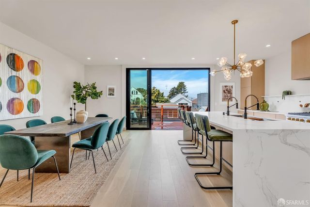 a view of a dining room with furniture and chandelier