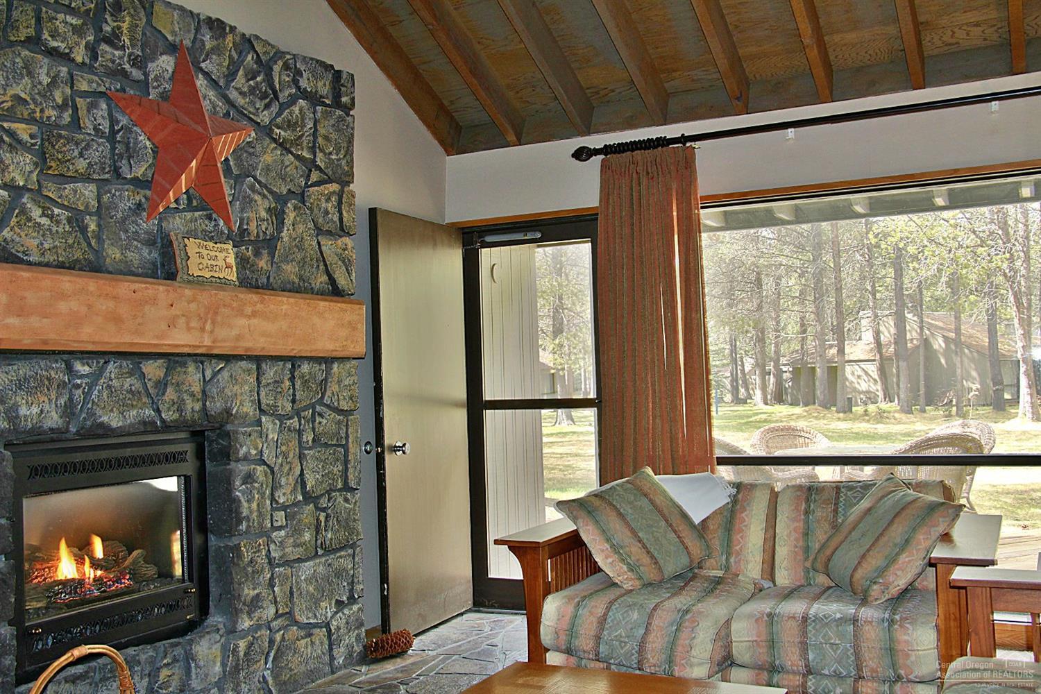 4 Meadow House Loop Sunriver, OR 97707 - Photo 6 of 17 a living room with furniture and a fireplace