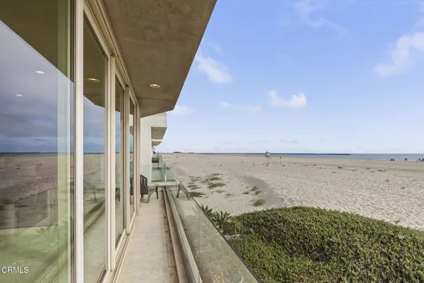 a view of a balcony with chair and ocean view