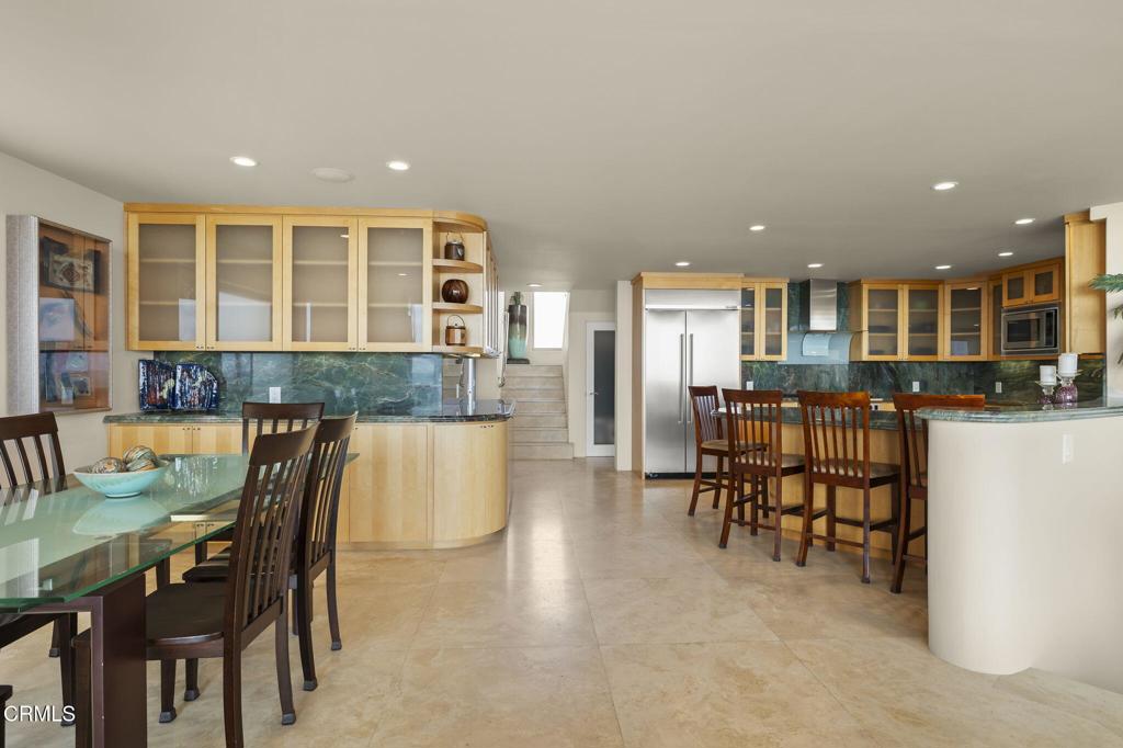 3629 Ocean Drive Oxnard, CA 93035 - Photo 20 of 60 a kitchen with a dining table chairs and refrigerator