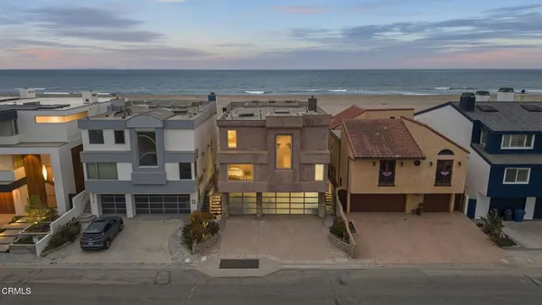 an aerial view of a building with glass windows and table