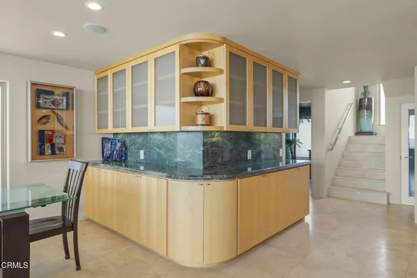 a kitchen with stainless steel appliances granite countertop a sink and a refrigerator