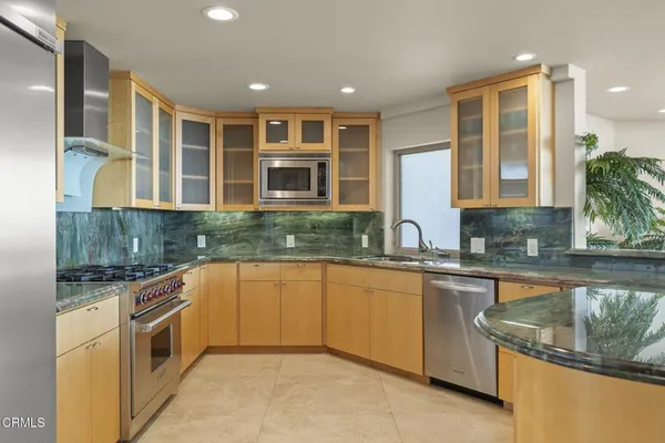 a kitchen with stainless steel appliances granite countertop a stove and a sink