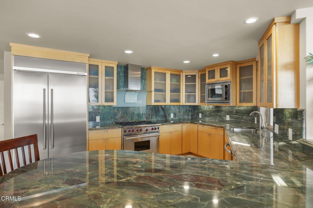 3629 Ocean Drive Oxnard, CA 93035 - Photo 24 of 60 a kitchen with stainless steel appliances granite countertop a sink and a refrigerator