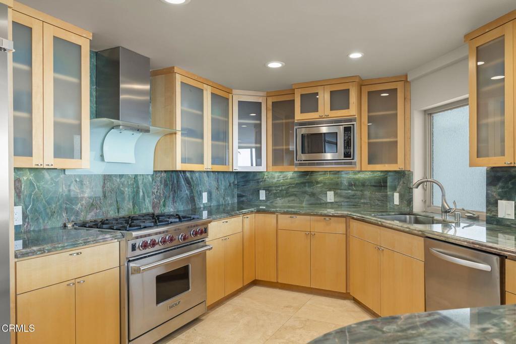 3629 Ocean Drive Oxnard, CA 93035 - Photo 25 of 60 a kitchen with stainless steel appliances granite countertop a stove and a sink