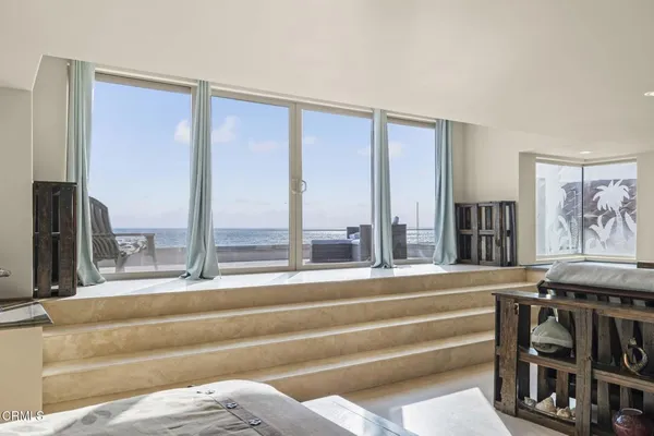 a living room with furniture and a floor to ceiling window