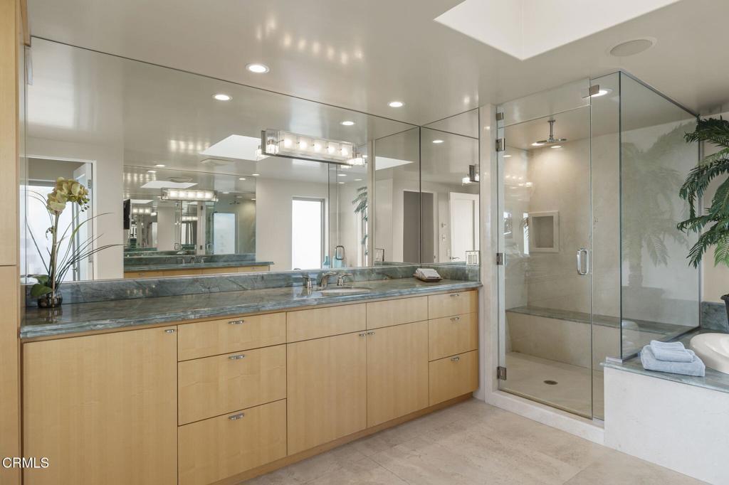 3629 Ocean Drive Oxnard, CA 93035 - Photo 44 of 60 a bathroom with a granite countertop sink mirror and shower