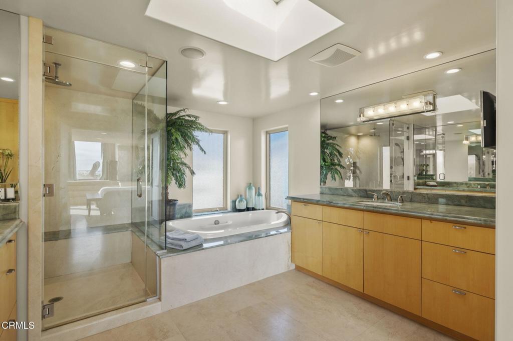 3629 Ocean Drive Oxnard, CA 93035 - Photo 45 of 60 a bathroom with a granite countertop sink mirror and a shower