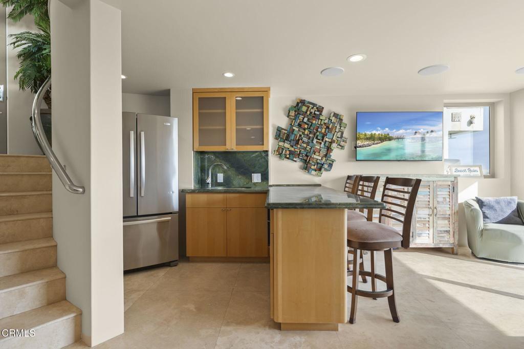 3629 Ocean Drive Oxnard, CA 93035 - Photo 51 of 60 a kitchen with stainless steel appliances granite countertop a refrigerator and a stove top oven