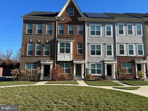 a front view of a residential apartment building with a yard