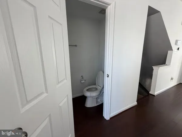 wooden floor in an empty room with a mirror