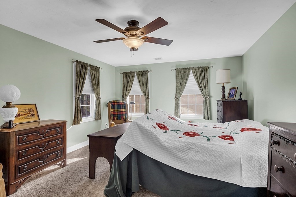 79 River Road Pepperell, MA 01463 - Photo 12 of 30 a bedroom with a bed a desk and chair with a bookshelf
