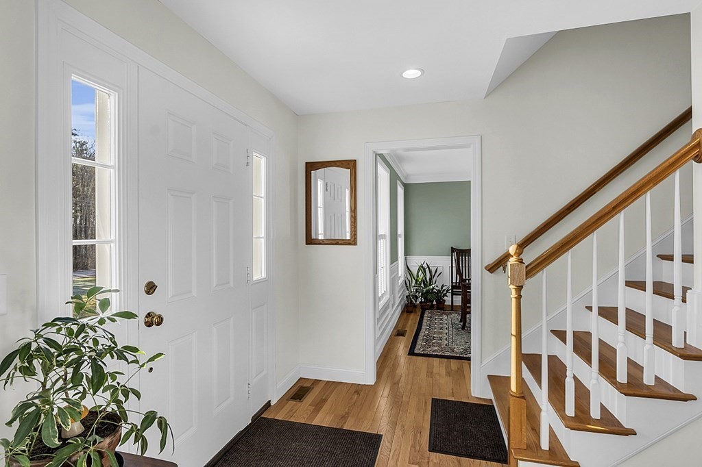 79 River Road Pepperell, MA 01463 - Photo 3 of 30 a view of a hallway with wooden floor and stairs