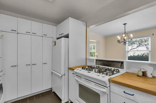 a kitchen with kitchen island a stove cabinets and wooden floor