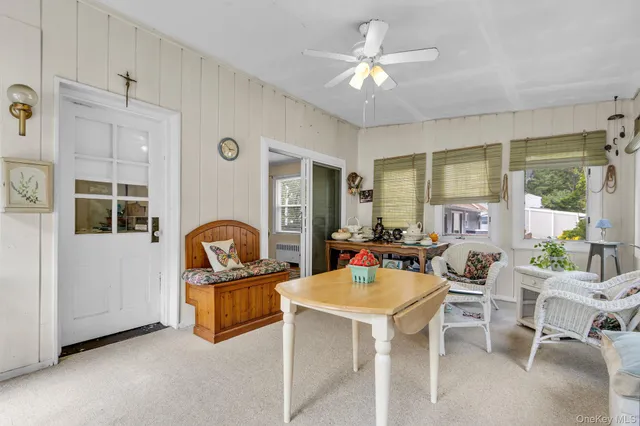 a living room with furniture a table and kitchen view